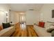 Spacious living room with hardwood floors, neutral walls, and a view of the home's entryway at 160 Vinnys Way, Covington, GA 30014