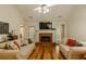 Bright living room featuring hardwood floors, a brick fireplace, and comfortable seating at 160 Vinnys Way, Covington, GA 30014