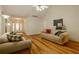 Open living room featuring hardwood floors, a cozy seating area, and entry view at 160 Vinnys Way, Covington, GA 30014