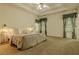 Spacious main bedroom with ceiling fan and natural light from the window at 160 Vinnys Way, Covington, GA 30014