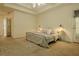 Lovely main bedroom featuring a ceiling fan, natural light, and neutral carpet at 160 Vinnys Way, Covington, GA 30014