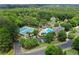 An aerial view of a community swimming pool and tennis courts, surrounded by lush trees at 1860 Hill Chase, Alpharetta, GA 30022