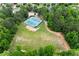 An aerial view of lush green field with community tennis courts and tall mature trees at 1860 Hill Chase, Alpharetta, GA 30022