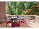 Cozy back deck with outdoor dining set and lush green backdrop, perfect for outdoor gatherings at 1860 Hill Chase, Alpharetta, GA 30022