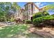 Expansive backyard with lush lawn, mature trees, stone patio, and outdoor seating, great for entertaining at 1860 Hill Chase, Alpharetta, GA 30022