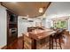 Entertaining bar featuring stone accents, dark wood finishes, and a built-in microwave at 1860 Hill Chase, Alpharetta, GA 30022