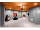 Open basement area with a jukebox, gray walls, orange ceiling, and doorway leading to the living room at 1860 Hill Chase, Alpharetta, GA 30022