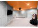 Finished basement space with gray walls, a projector, orange ceiling, and a retro jukebox at 1860 Hill Chase, Alpharetta, GA 30022