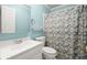 Cozy bathroom with a patterned shower curtain and soft blue walls at 1860 Hill Chase, Alpharetta, GA 30022