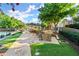 Community patio with stone grill, outdoor seating, and a covered pavilion with views of the tennis courts at 1860 Hill Chase, Alpharetta, GA 30022