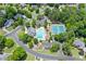 Aerial view features the community pool, tennis courts, parking lot, and surrounding residential neighborhood at 1860 Hill Chase, Alpharetta, GA 30022