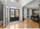 Elegant entryway with double doors, gleaming hardwood floors, and sophisticated dining room view at 1860 Hill Chase, Alpharetta, GA 30022
