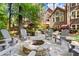 Backyard fire pit with Adirondack chairs and view of home's rear exterior at 1860 Hill Chase, Alpharetta, GA 30022