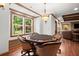 Inviting game room with a poker table, an outdoor view, and hardwood floors at 1860 Hill Chase, Alpharetta, GA 30022