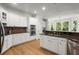 Bright kitchen featuring white cabinets, stainless steel appliances, and a brick backsplash at 1860 Hill Chase, Alpharetta, GA 30022