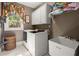 Functional laundry room with washer, dryer, utility sink, storage cabinets, and a window for natural light at 1860 Hill Chase, Alpharetta, GA 30022