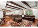 Expansive living room with dark wood floors, a stone bar, and a large sectional at 1860 Hill Chase, Alpharetta, GA 30022