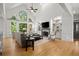 Bright living room features vaulted ceilings, built-in shelving, a fireplace, and large windows at 1860 Hill Chase, Alpharetta, GA 30022