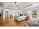 Bright main bedroom featuring hardwood floors, a tray ceiling, and neutral decor at 1860 Hill Chase, Alpharetta, GA 30022