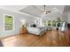 Spacious main bedroom featuring tray ceiling, hardwood floors, natural light, and a sitting area at 1860 Hill Chase, Alpharetta, GA 30022