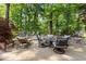 Backyard patio featuring stone walls, cushioned chairs, and lush greenery at 1860 Hill Chase, Alpharetta, GA 30022