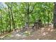 Wooded backyard featuring a playground structure with a slide and swing set at 1860 Hill Chase, Alpharetta, GA 30022