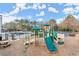 A wooden playground with slides and climbing features, a picnic table, and a swimming pool in the background at 1860 Hill Chase, Alpharetta, GA 30022