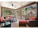 Inviting screened porch with comfortable seating, ceiling fan, and a peaceful view of the surrounding greenery at 1860 Hill Chase, Alpharetta, GA 30022