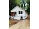 Inviting exterior showcasing a board and batten facade, small porch and concrete driveway with wet weather at 2004 Detroit Nw Ave, Atlanta, GA 30314