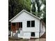 Quaint front view of a board and batten home with a small porch and dark frame windows at 2004 Detroit Nw Ave, Atlanta, GA 30314
