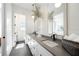 Bright bathroom features dual vanities, a large mirror, and modern fixtures plus a basket of white towels at 260 2Nd St, Fayetteville, GA 30214