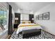 Stylish bedroom with king bed, black curtains, modern art, and view from window offering lots of natural light at 260 2Nd St, Fayetteville, GA 30214