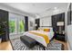 Bright bedroom with king bed, stylish black curtains, modern rug, and a tranquil view from two windows at 260 2Nd St, Fayetteville, GA 30214