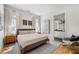 Bright bedroom features neutral decor, a soft rug, and an adjacent bathroom with elegant lighting at 260 2Nd St, Fayetteville, GA 30214