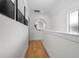 Bright hallway with hardwood floors, a round mirror, and white walls, creating a clean and open space at 260 2Nd St, Fayetteville, GA 30214
