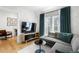 Cozy living room featuring a comfortable gray sectional, modern TV, and stylish decor at 260 2Nd St, Fayetteville, GA 30214