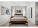 Cozy bedroom with large windows, neutral tones, and elegant decor creating a relaxing space at 260 2Nd St, Fayetteville, GA 30214