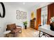Well-lit home office with hardwood floors, stylish decor, and a large window with vibrant orange curtains at 260 2Nd St, Fayetteville, GA 30214