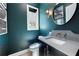 Stylish powder room features a dark accent wall, modern mirror, and floating vanity at 260 2Nd St, Fayetteville, GA 30214