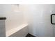 Modern tiled shower with built-in bench, a niche, and black trim on the glass door at 260 2Nd St, Fayetteville, GA 30214