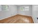 Cozy bedroom with hardwood floors and natural light from two windows at 2921 Country Squire Ln, Decatur, GA 30033