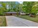 Charming home featuring a well-maintained lawn, mature trees, and a convenient covered parking area at 2921 Country Squire Ln, Decatur, GA 30033