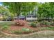 Charming home featuring a manicured front yard with mature trees and colorful landscaping at 2921 Country Squire Ln, Decatur, GA 30033