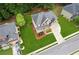 Aerial view of a beautiful brick home with a pristine lawn and mature trees at 927 Ivey Chase Pl, Dacula, GA 30019