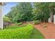 Beautifully landscaped backyard featuring lush greenery, manicured bushes, and mature trees, offering privacy and tranquility at 927 Ivey Chase Pl, Dacula, GA 30019