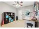 Neutral bedroom with ceiling fan, a bookshelf, and a work desk at 927 Ivey Chase Pl, Dacula, GA 30019