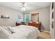 Serene bedroom featuring a ceiling fan, dresser with mirror, and a window with views to the outdoors at 927 Ivey Chase Pl, Dacula, GA 30019