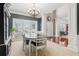 Formal dining room featuring elegant chandelier, large windows, and neutral carpet at 927 Ivey Chase Pl, Dacula, GA 30019