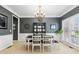 Traditional dining room with an elegant chandelier, gray walls, and large window at 927 Ivey Chase Pl, Dacula, GA 30019
