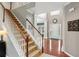 A bright foyer featuring hardwood floors, a staircase, and a view of the front door at 927 Ivey Chase Pl, Dacula, GA 30019